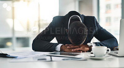 Buy stock photo Cropped shot of a young businessman sleeping at his desk after a long and tiring day