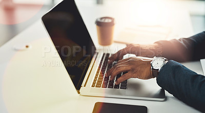 Buy stock photo Cropped shot of an unrecognizable young businessman working on his laptop in a modern office