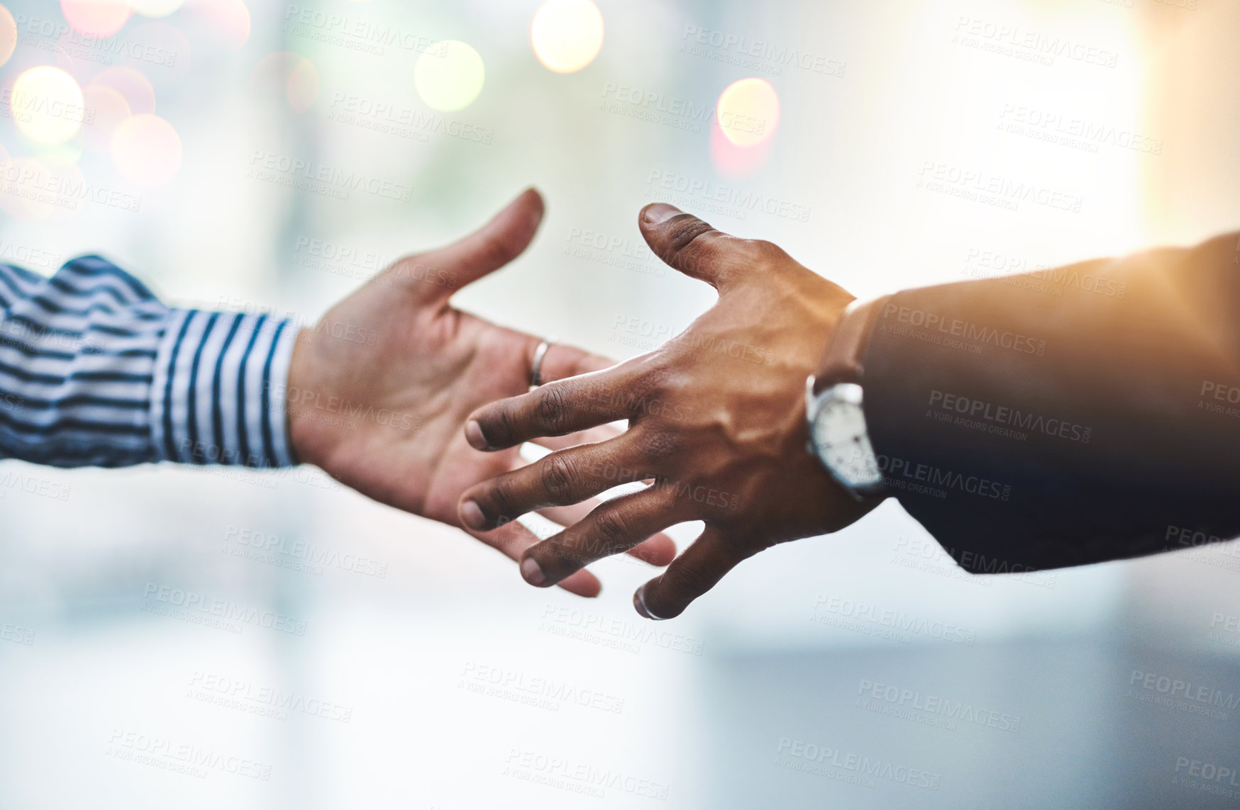 Buy stock photo Closeup shot of two unrecognizable businesspeople shaking hands in an office