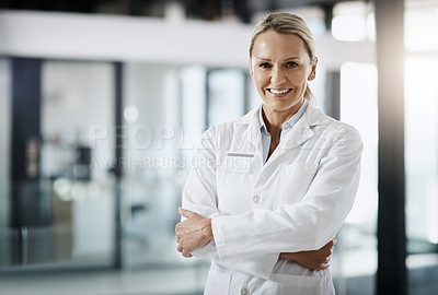 Buy stock photo Cropped portrait of an attractive mature female scientist standing with her arms folded in her lab