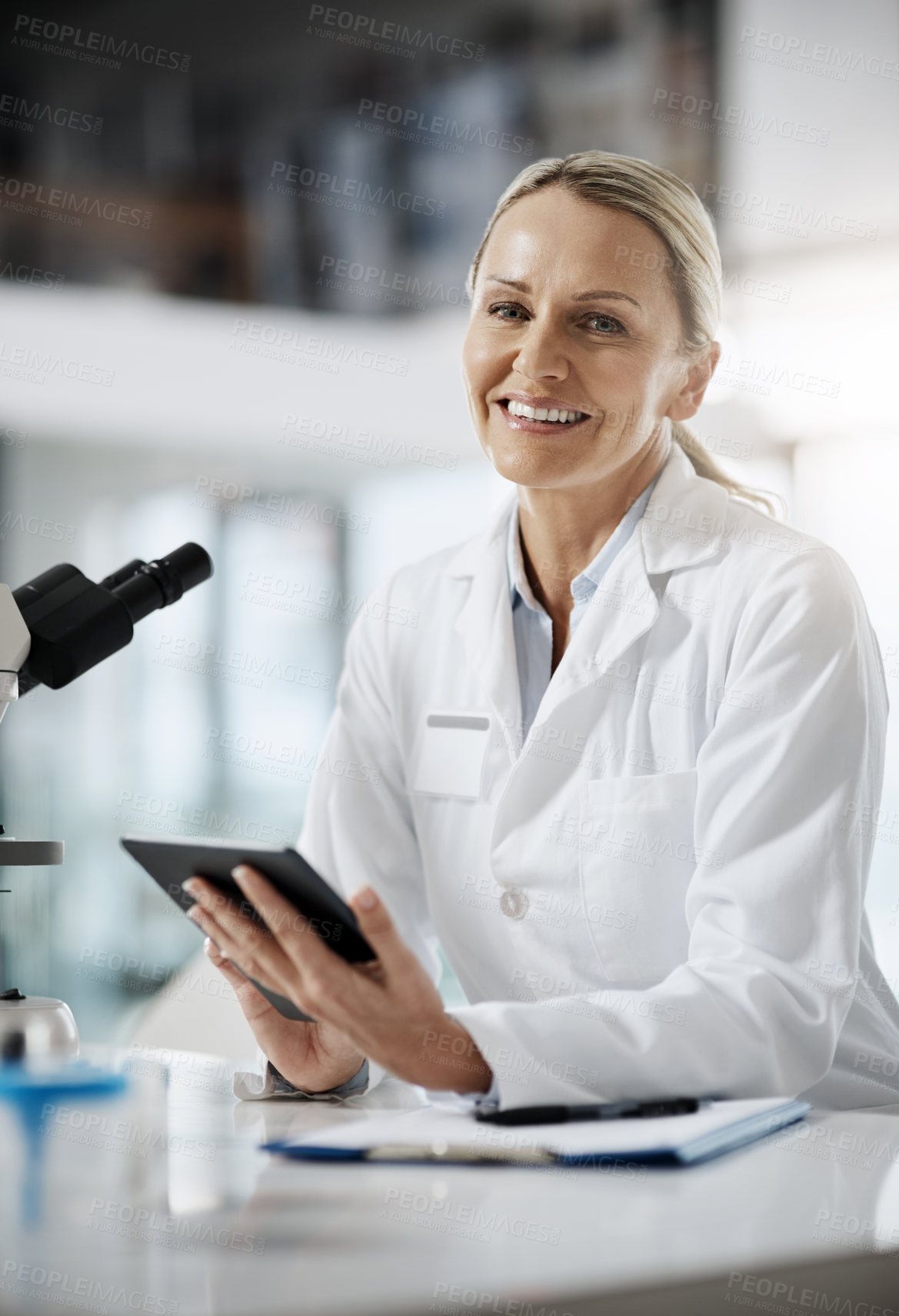 Buy stock photo Cropped portrait of an attractive mature female scientist using a tablet while doing research in her lab