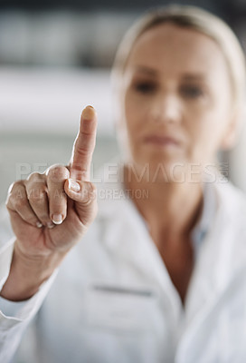 Buy stock photo Cropped shot of a mature female scientist working on touchscreen technology while doing research in her lab