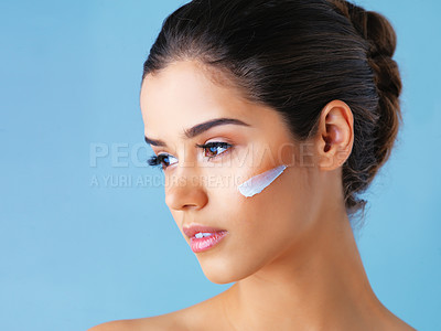 Buy stock photo Thinking, skincare and girl with face cream in studio mockup for wellness, cosmetics or skin detox on blue background. Beauty, sunscreen or model with how to, tips or diy makeup removal product idea