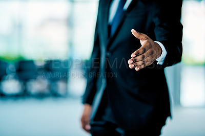 Buy stock photo Closeup of an unrecognizable businessman stretching put his hand for a handshake in the office at work during the day