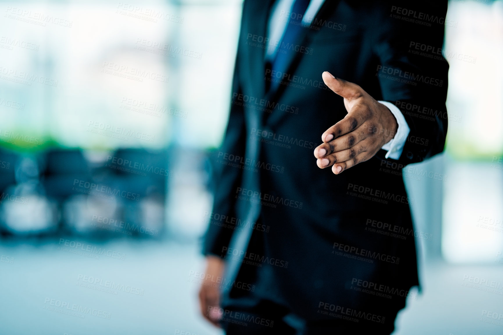 Buy stock photo Closeup of an unrecognizable businessman stretching put his hand for a handshake in the office at work during the day