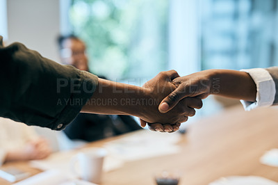 Buy stock photo Closeup of two unrecognizable businesspeople shaking hands in the office at work during the day