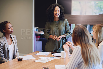Buy stock photo High angle shot of an attractive young businesswoman addressing her colleagues during a meeting in the boardroom