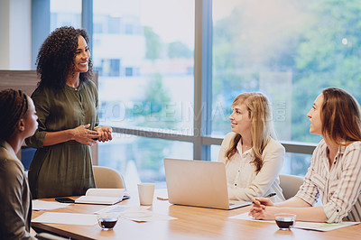 Buy stock photo Cropped shot of an attractive young businesswoman addressing her colleagues during a meeting in the boardroom