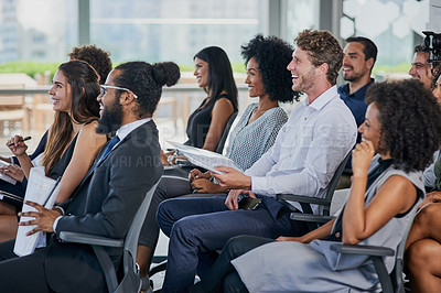 Buy stock photo Cropped shot of a group of businesspeople sitting in the conference room during a seminar