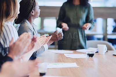 Buy stock photo Low angle shot of a group of businesspeople applauding a colleague while sitting in the boardroom during a meeting