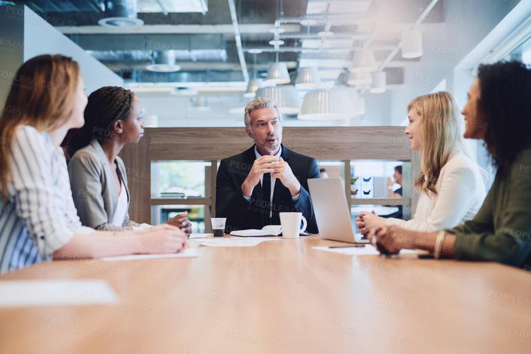 Buy stock photo Low angle shot of a handsome mature businessman addressing his colleagues during a meeting in the boardroom