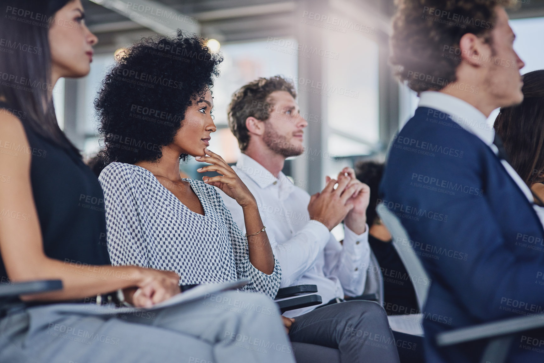 Buy stock photo Low angle shot of a group of businesspeople sitting in the conference room during a seminar