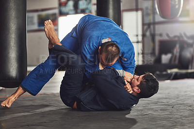 Buy stock photo Full length shot of two professional fighters sparring in the gym
