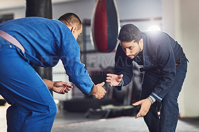Buy stock photo Cropped shot of two professional fighters sparring in the gym
