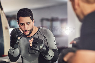 Buy stock photo Cropped shot of two professional fighters sparring in the gym