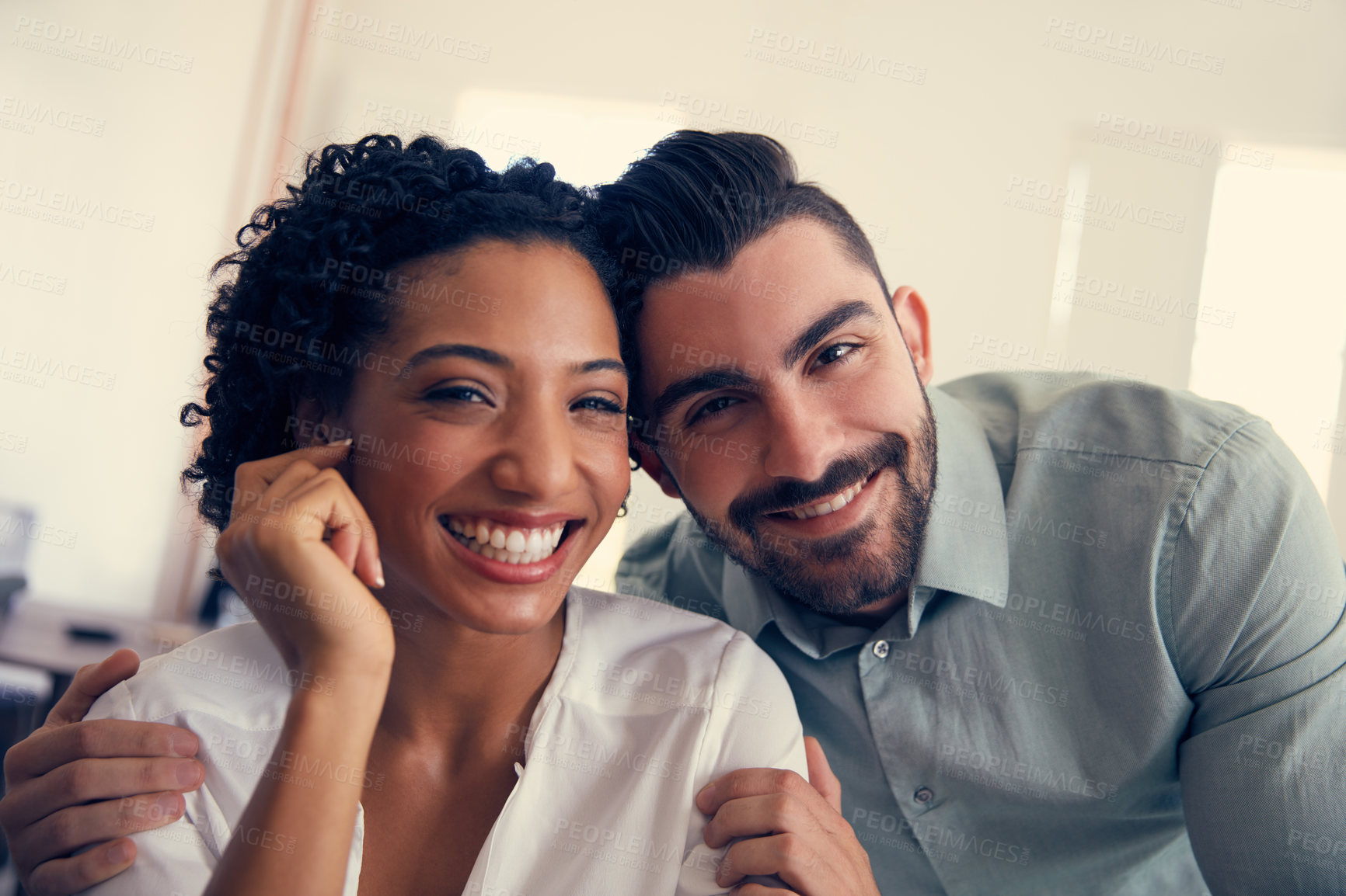 Buy stock photo Portrait of a young affectionate couple in the office
