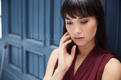 Buy stock photo Cropped shot of a young attractive businesswoman feeling depressed in a corridor at the office