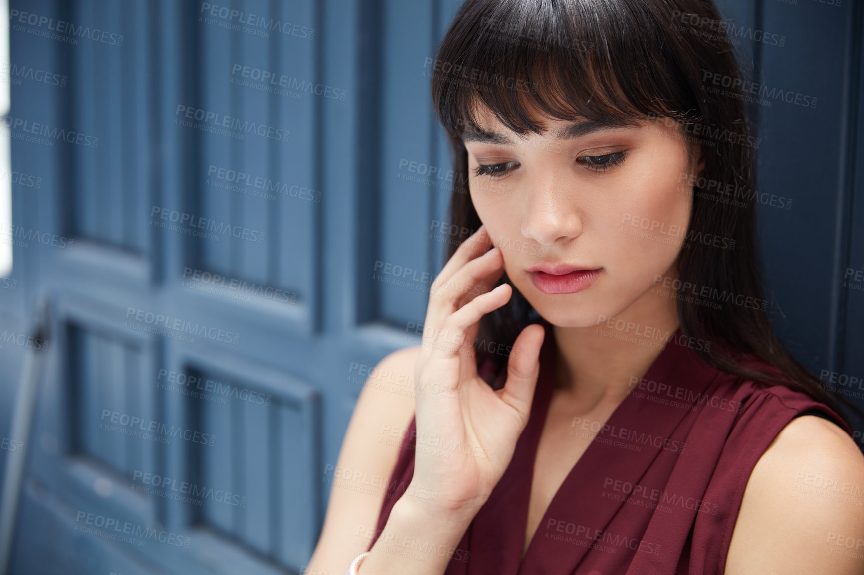 Buy stock photo Cropped shot of a young attractive businesswoman feeling depressed in a corridor at the office