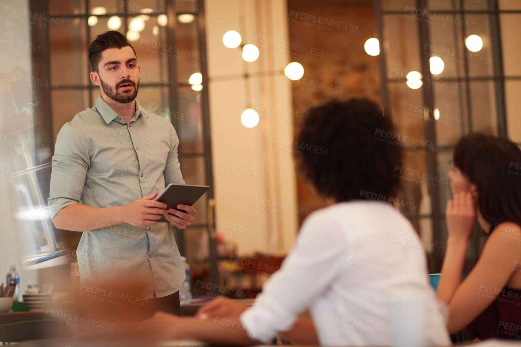 Buy stock photo Cropped shot of young businesspeople having a meeting in the office