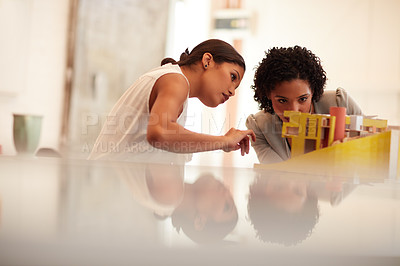 Buy stock photo Cropped shot of young businesswomen working together in the office