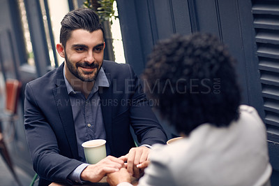 Buy stock photo Cropped shot of a young attractive couple having coffee at a cafe