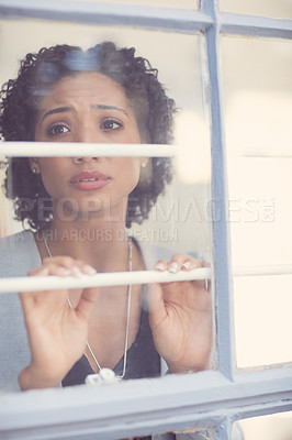 Buy stock photo Cropped shot of a young attractive woman feeling depressed at home