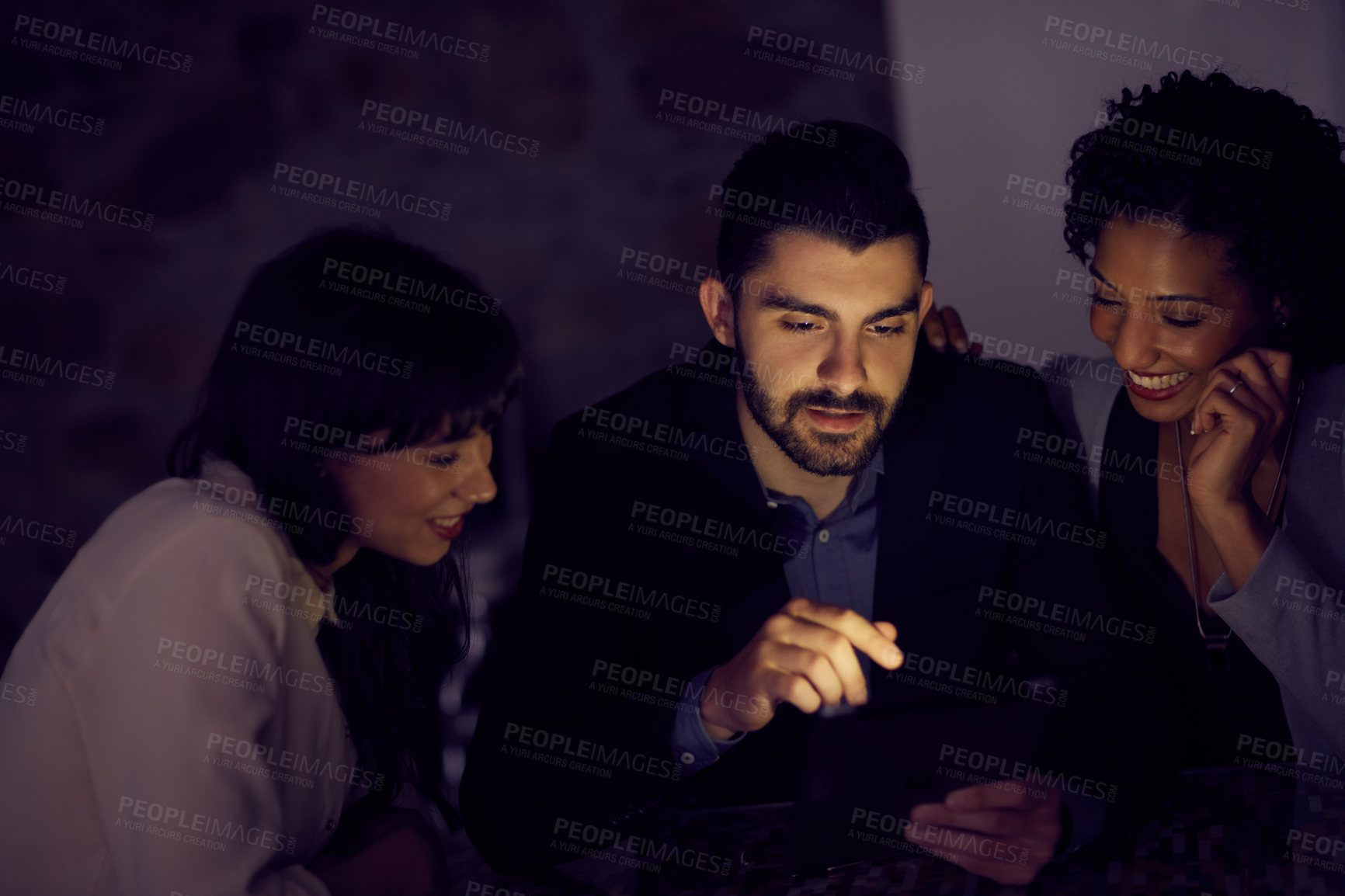 Buy stock photo Cropped shot of young businesspeople using a tablet together in the office