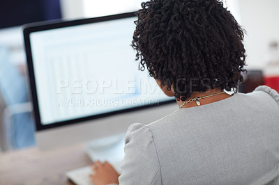 Buy stock photo Rearview shot of an unrecognizable businesswoman working in the office