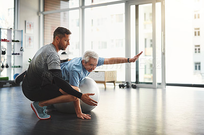 Buy stock photo Stretching, elderly man and physiotherapist with ball for mobility training, support or muscle workout. Fitness, physiotherapy and senior person with exercise, development or healthcare in retirement