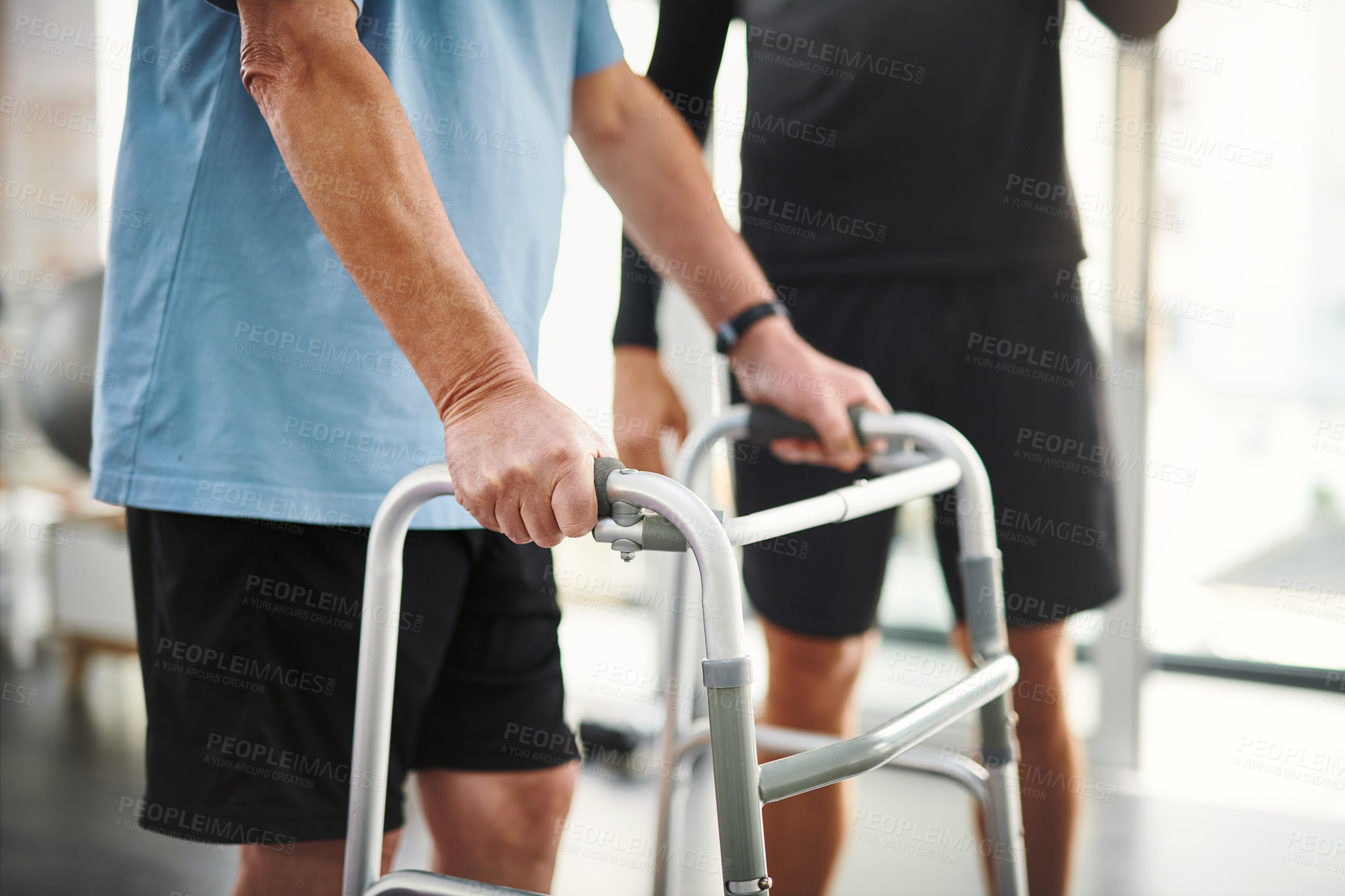 Buy stock photo Help, physiotherapy and hands of old man with walker for rehabilitation, senior care and workout. Balance, fitness and elderly patient with mobility training, exercise and health in retirement clinic