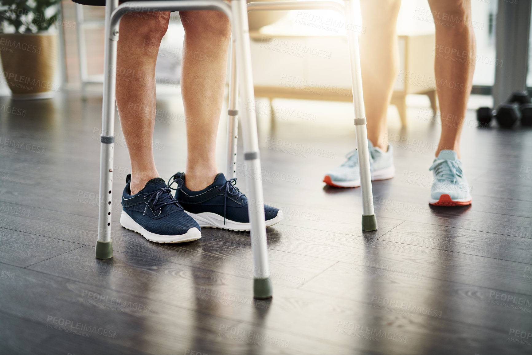 Buy stock photo Closeup shot of a physiotherapist assisting a senior patient with a walker while in recovery