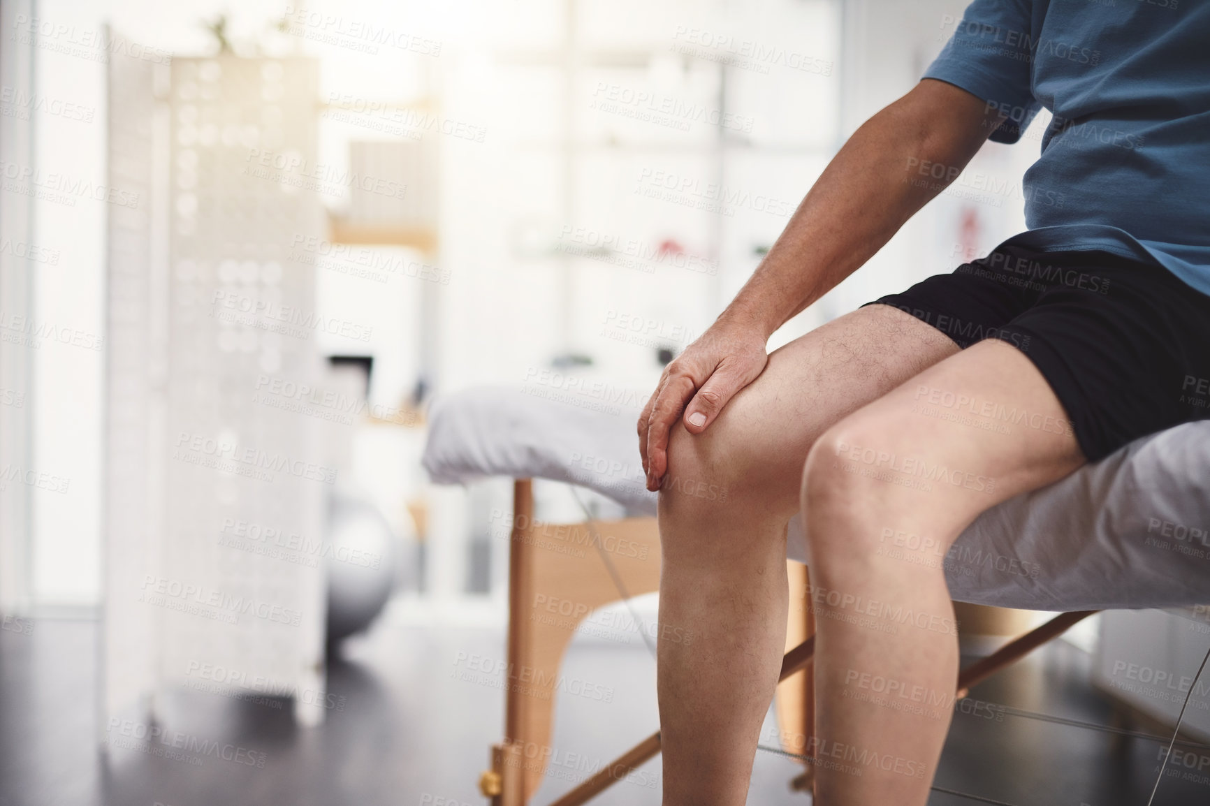 Buy stock photo Knee pain, injury and old man in rehabilitation center for holistic healing, chiropractor and physiotherapy. Healthcare, muscle tension and accident with senior patient in physical therapy clinic