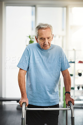 Buy stock photo Shot of a senior man using a walker in a rehabilitation centre