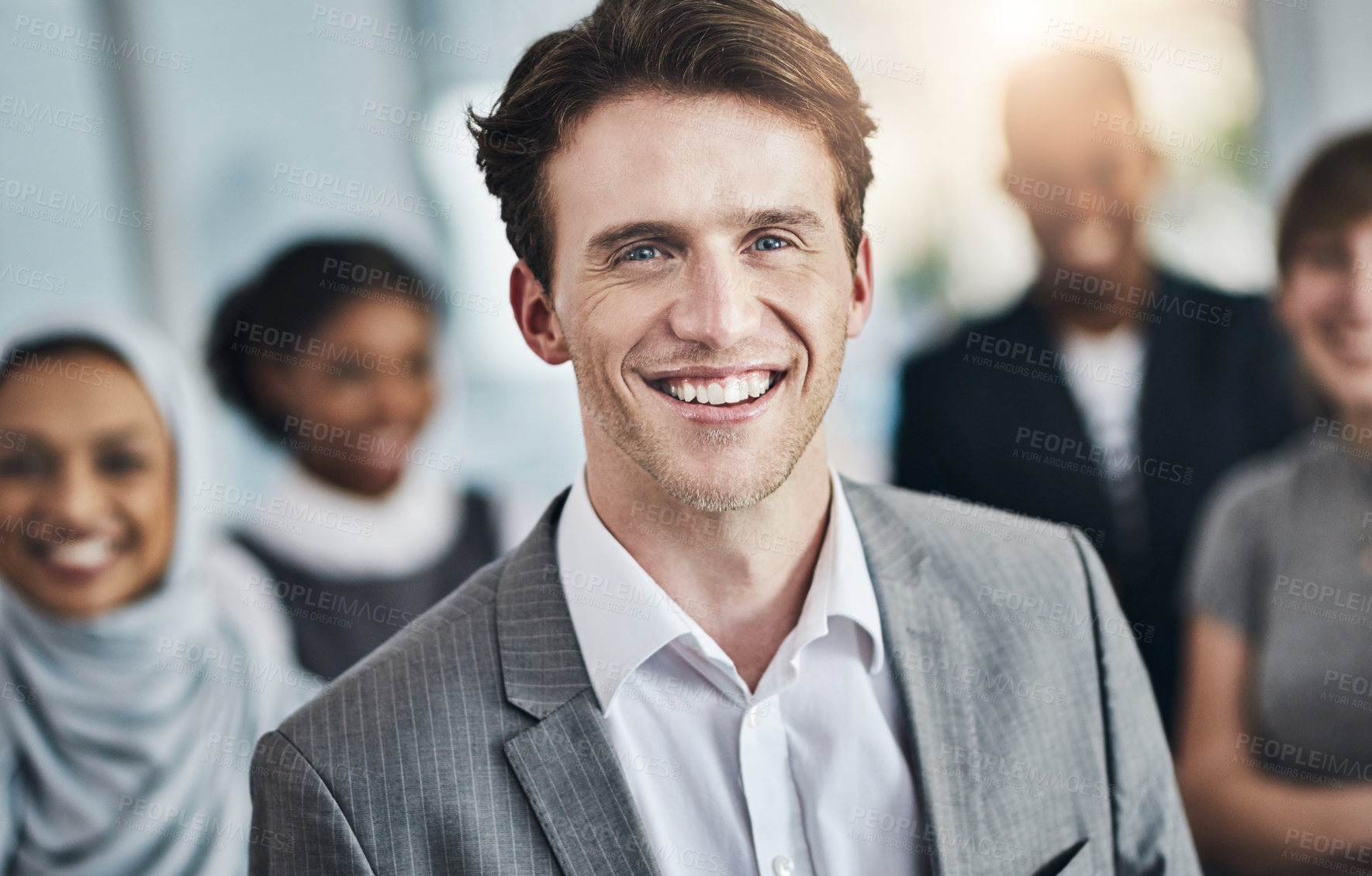Buy stock photo Portrait of a cheerful young businessman standing in the office at work during the day