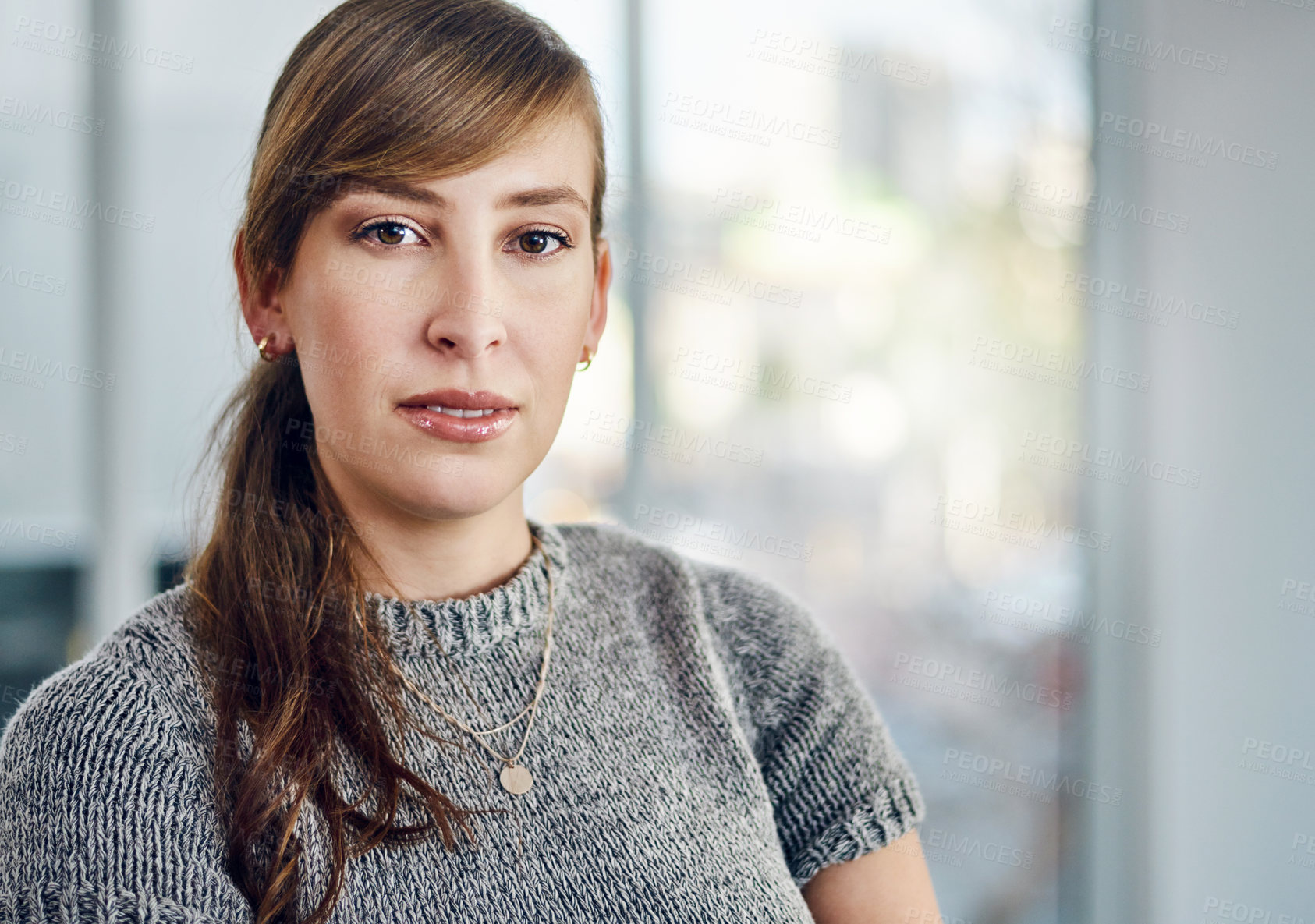 Buy stock photo Portrait of a confident young businesswoman standing inside the office at work