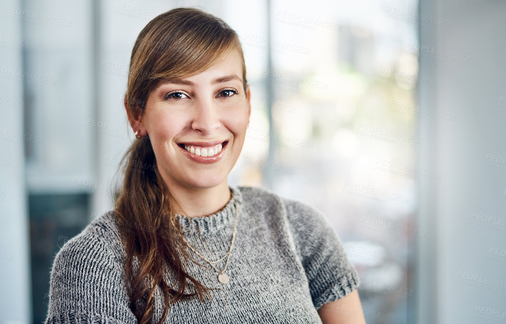 Buy stock photo Portrait of a confident young businesswoman standing inside the office at work