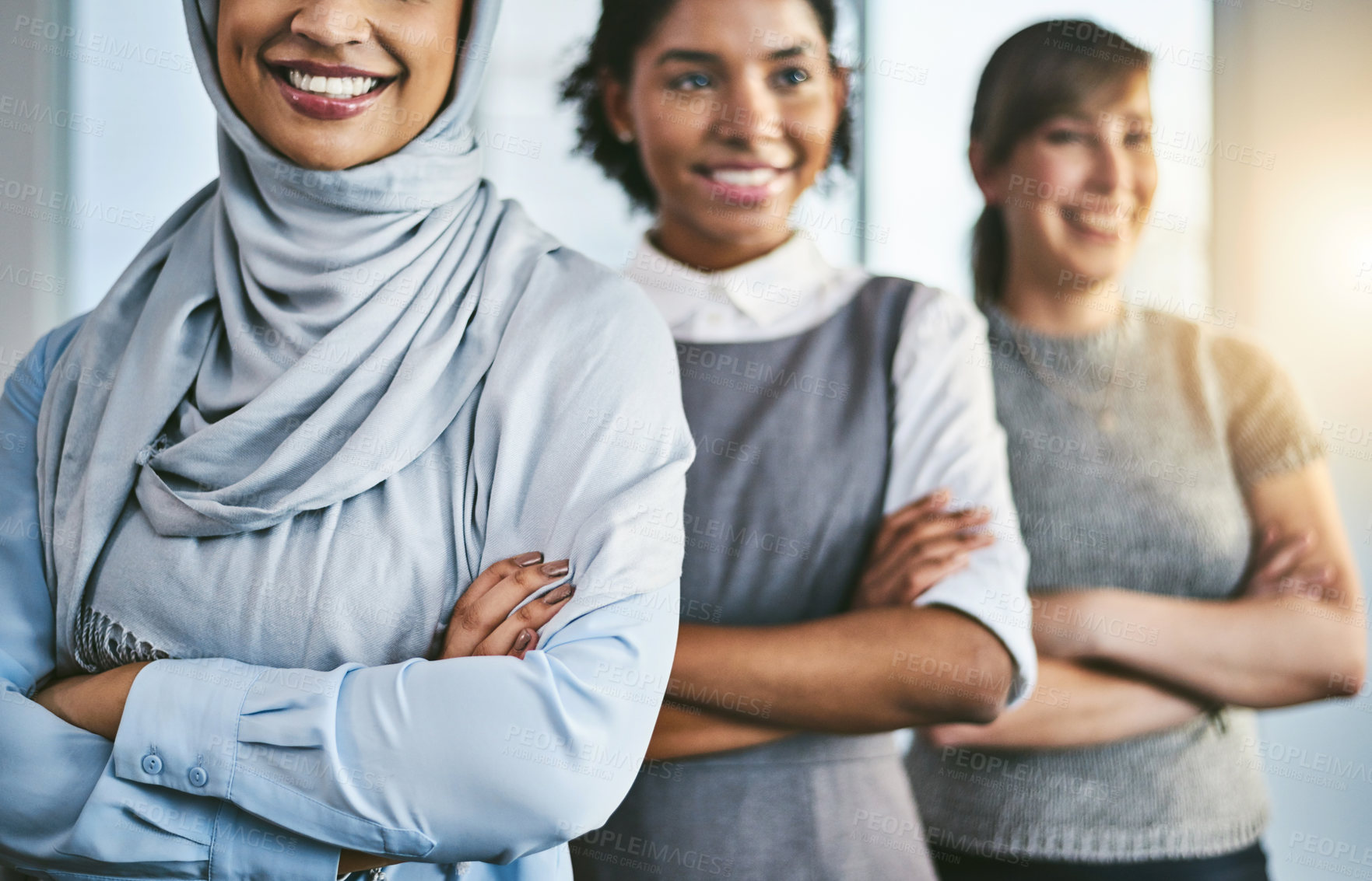 Buy stock photo Portrait of a group of young confident businesswomen standing in a row behind each other inside of the office during the day