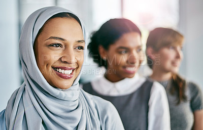 Buy stock photo Portrait of a group of young confident businesswomen standing in a row behind each other inside of the office during the day