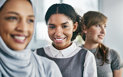 Buy stock photo Portrait of a group of young confident businesswomen standing in a row behind each other inside of the office during the day