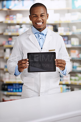 Buy stock photo Portrait of a young pharmacist holding up a digital tablet with a blank screen in a chemist