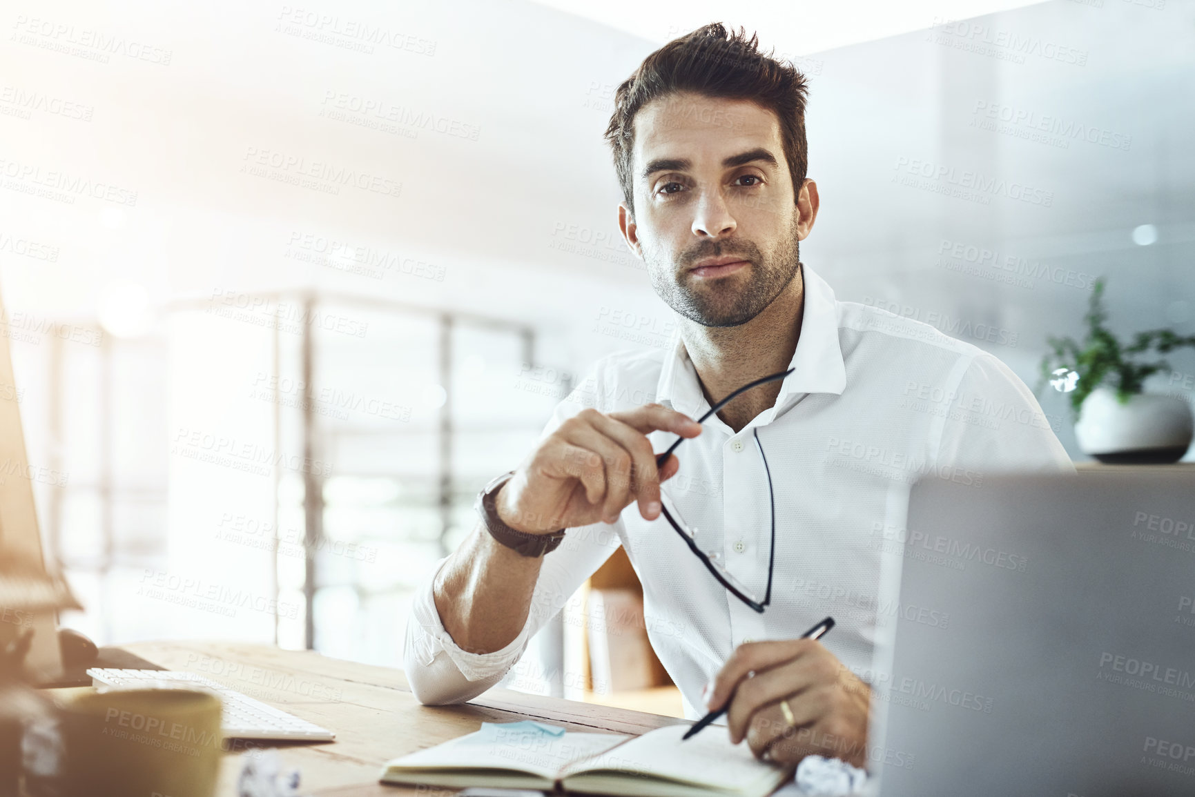 Buy stock photo Business, man and portrait with laptop at office on website or online for research and information. Lens flare, male person and serious as employee on diary or notebook on internet as project manager