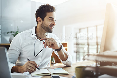 Buy stock photo Shot of a young businessman working in an office