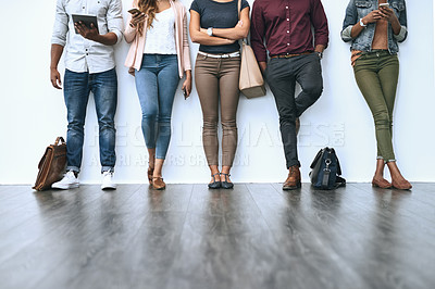 Buy stock photo Shot of a group of diverse people waiting in line to be interviewed
