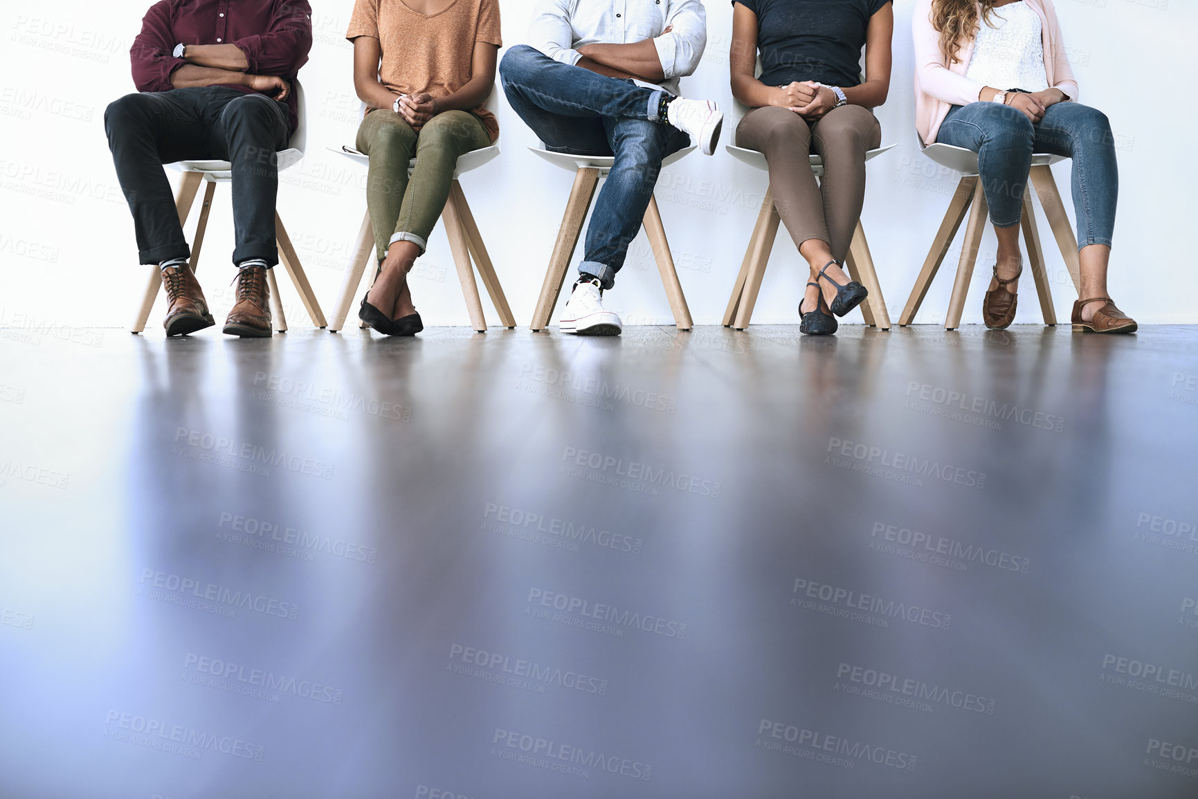 Buy stock photo Shot of a group of diverse people waiting in line to be interviewed