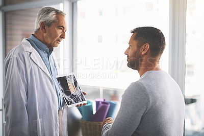 Buy stock photo Doctor, man and tablet for xray consultation with spine anatomy, diagnosis review and inflammation. Mature radiologist, patient and digital app for health assessment or medical analysis of skeleton