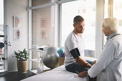 Buy stock photo Healthcare, man and doctor with blood pressure test, checkup and assessment in clinic. Fitness, patient and medical professional checking for hypertension, physio or health insurance consultation