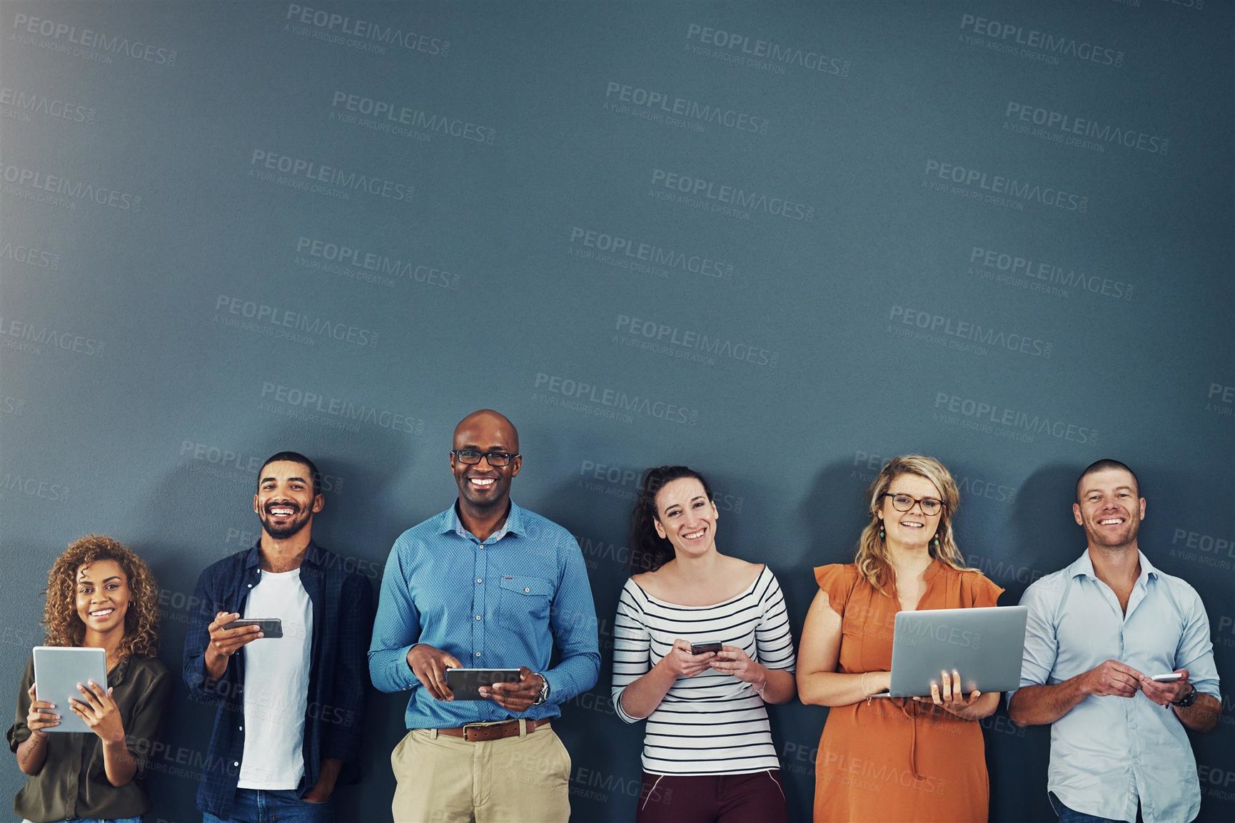 Buy stock photo Studio shot of a group of diverse people social networking against a gray background