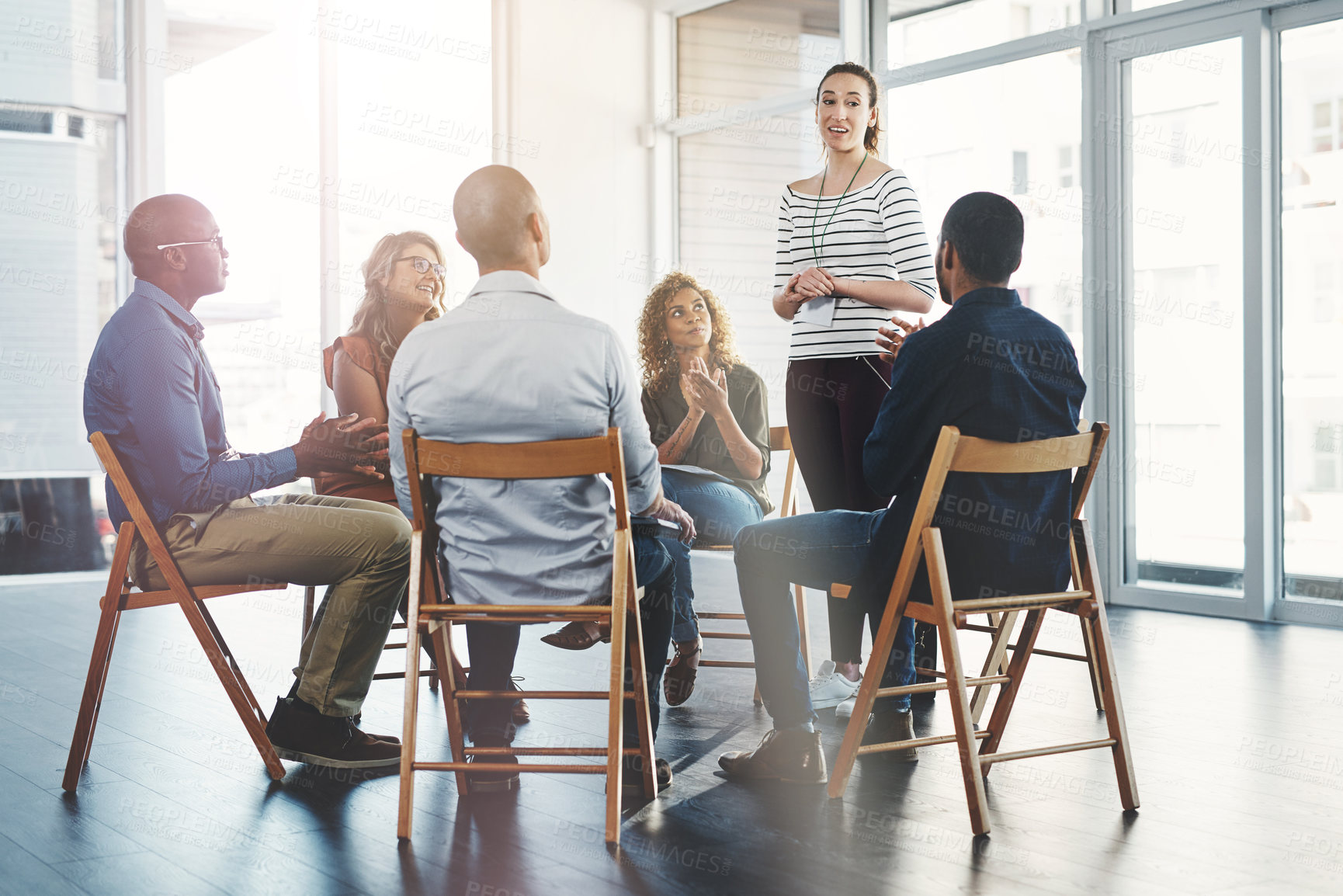 Buy stock photo Woman, talking and circle for training in office with diversity, meeting and brainstorming for solution. Person, presentation and group in scrum, teamwork and workshop for project at creative agency