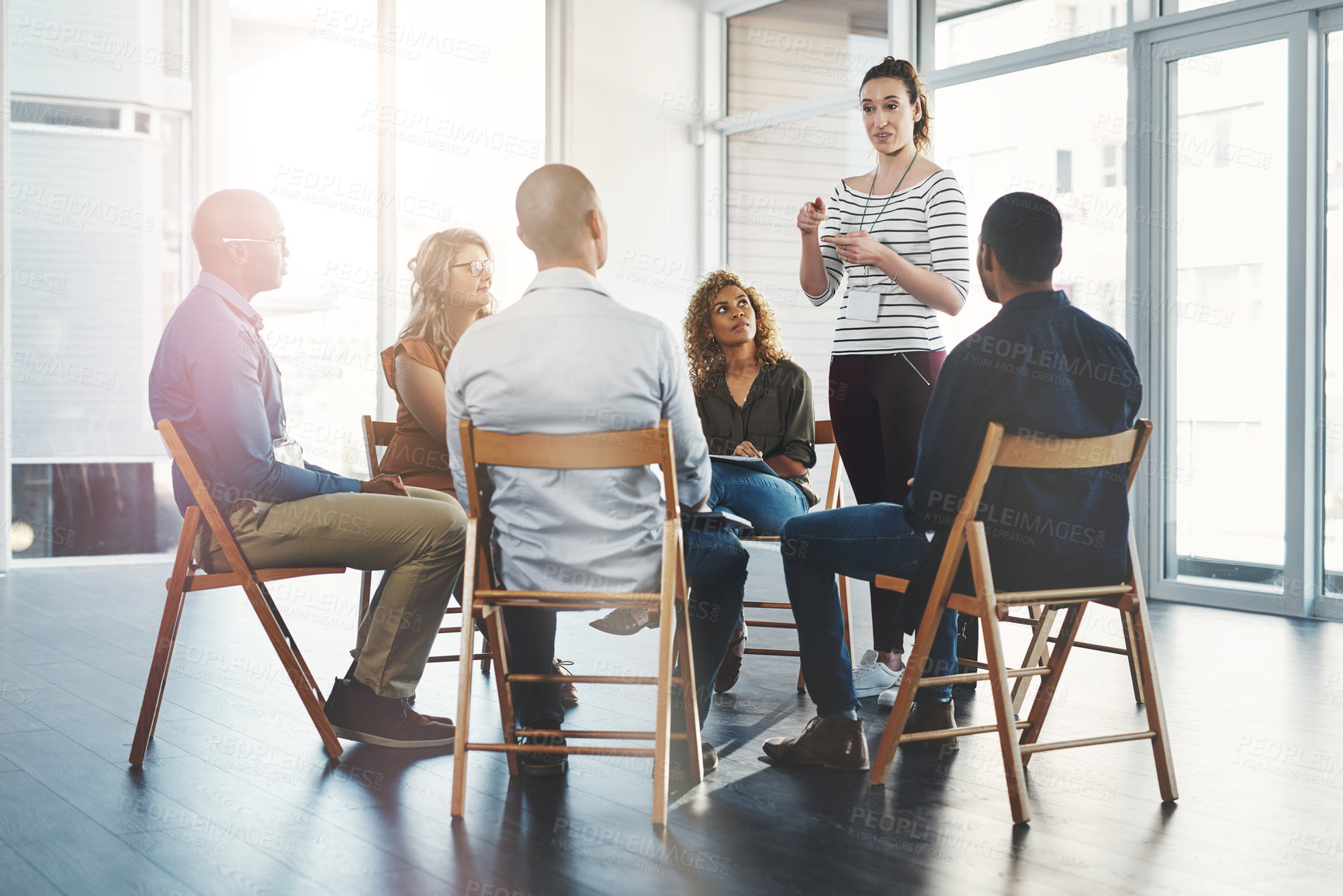 Buy stock photo Woman, workshop and circle for training in office with diversity, meeting and brainstorming for solution. Person, presentation and group in scrum, teamwork and listening to ideas at creative agency