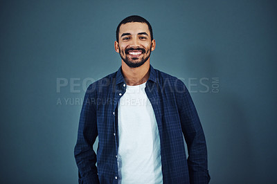Buy stock photo Studio portrait of a confident man posing against a gray background